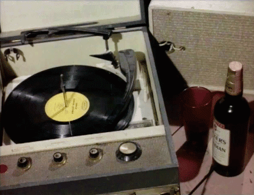 Retro record player and a bottle of wine